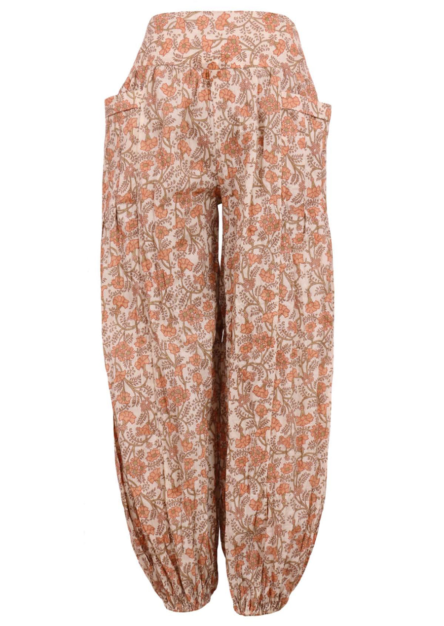 Model wears 100% cotton pants with an elastic waist and ankles. These loose fitting pants have pockets and feature a floral peach and green print on a cream base