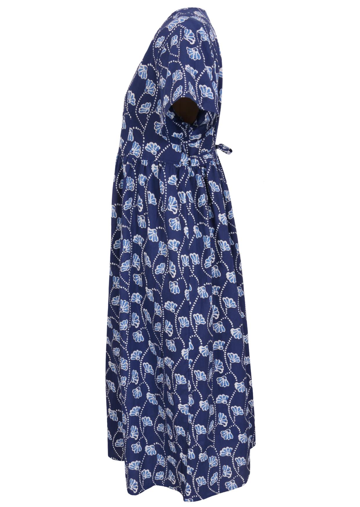 Side view of navy blue based floral print V-neck cotton dress with pockets.