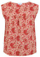 Cap sleeves cotton top with cream based warm floral print on a white background.