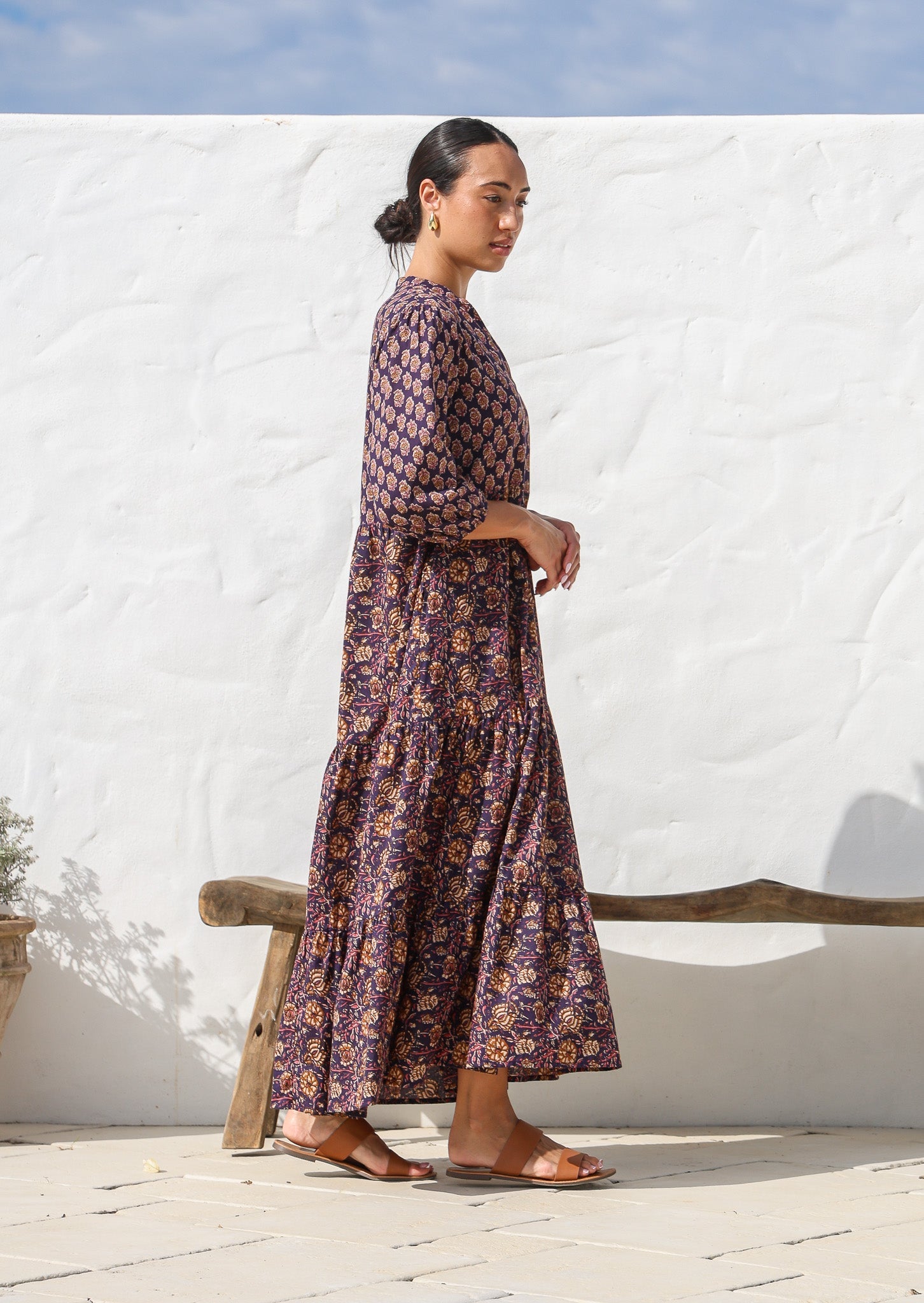 Model wearing a 100% cotton 3 tiered maxi dress with flowy skirt, 3/4 sleeves, buttoned bodice and pockets.