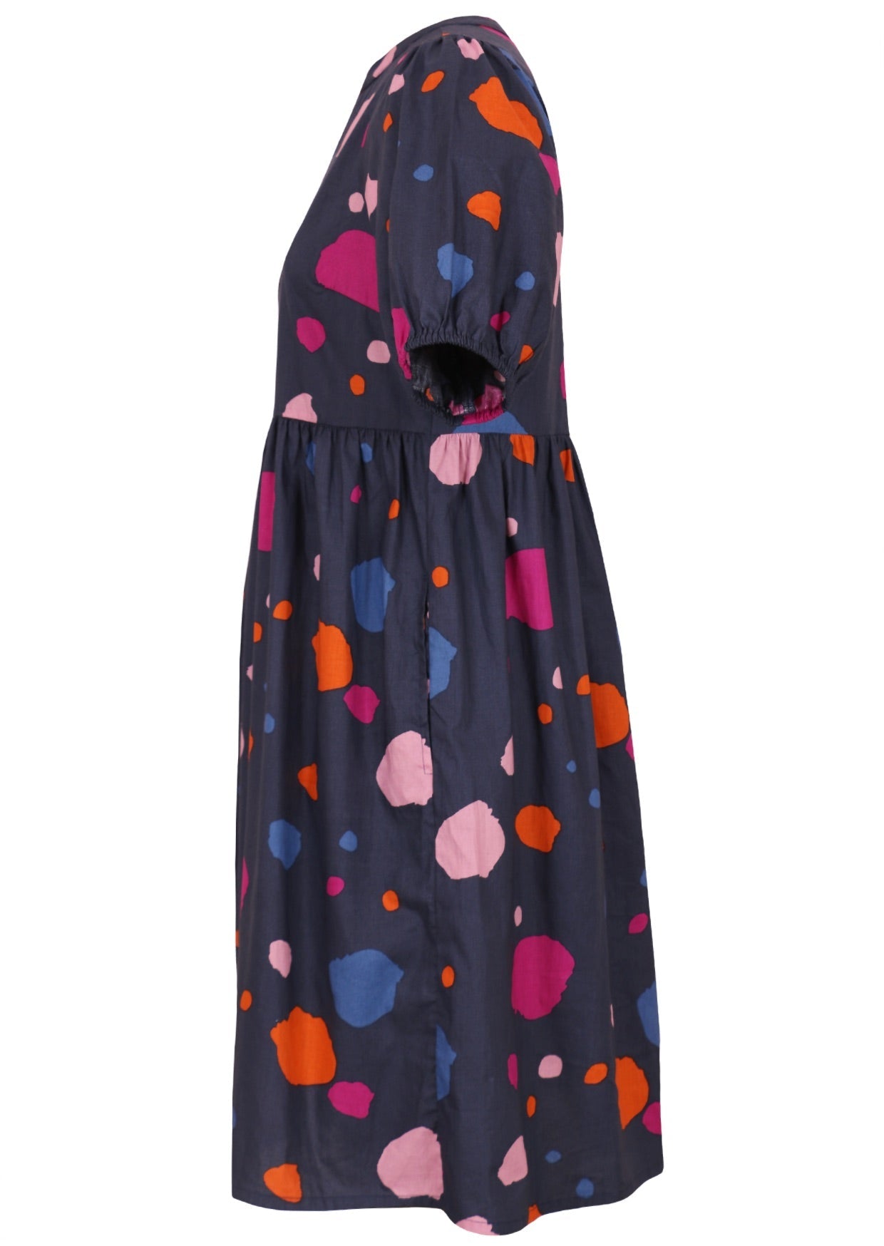 Side view of knee length navy blue based colorful printed dress with cuffed elastic sleeves and mandarin collar.