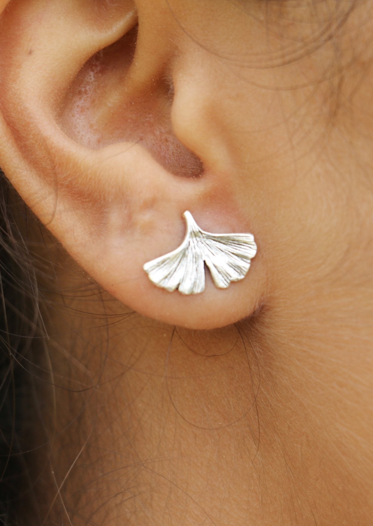 Elegant sterling silver Ginkgo Studs showcasing the fan-shaped leaf with gentle curves and secured butterfly backs