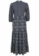 100% navy blue based floral three tiered flowy maxi dress with buttoned bodice, 3/4 sleeves and mandarin collar 