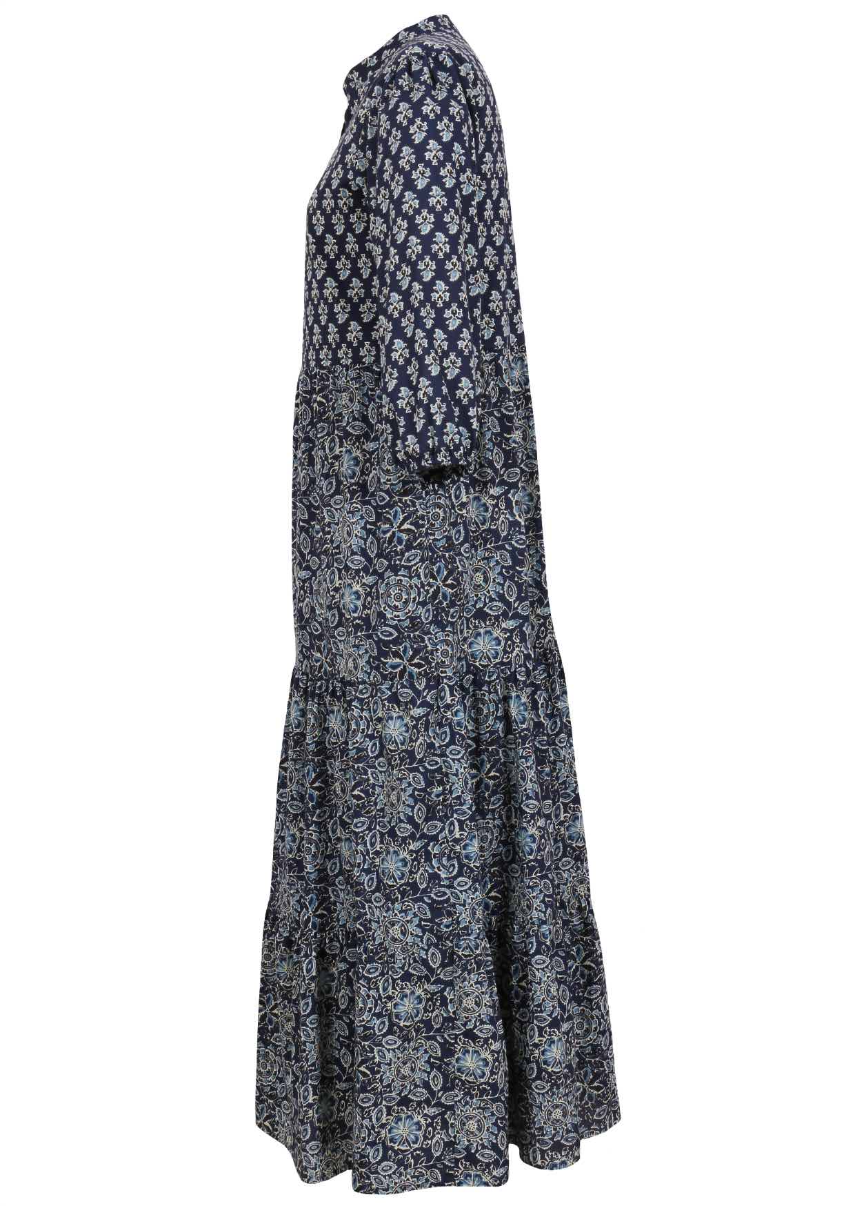 Side view of a full length maxi dress with 3 tiered flowy skirt, mandarin collar, buttoned bodice and pockets