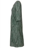 Side view of relaxed fit below knee length cotton dress with 3/4 sleeves, pockets and round neckline.