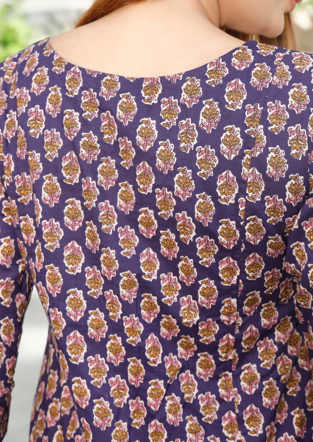 Close up image of back of the dress showcasing beautiful purple based floral print.