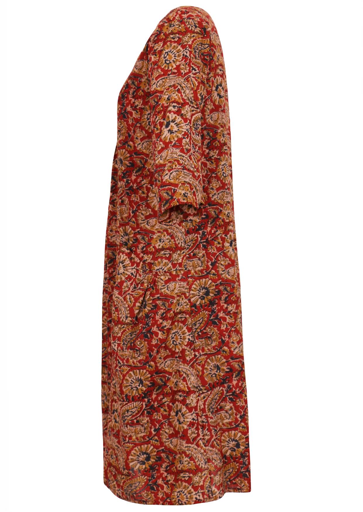 Side image of cotton red dress with earthy warm florals, 3/4 sleeves and pockets.
