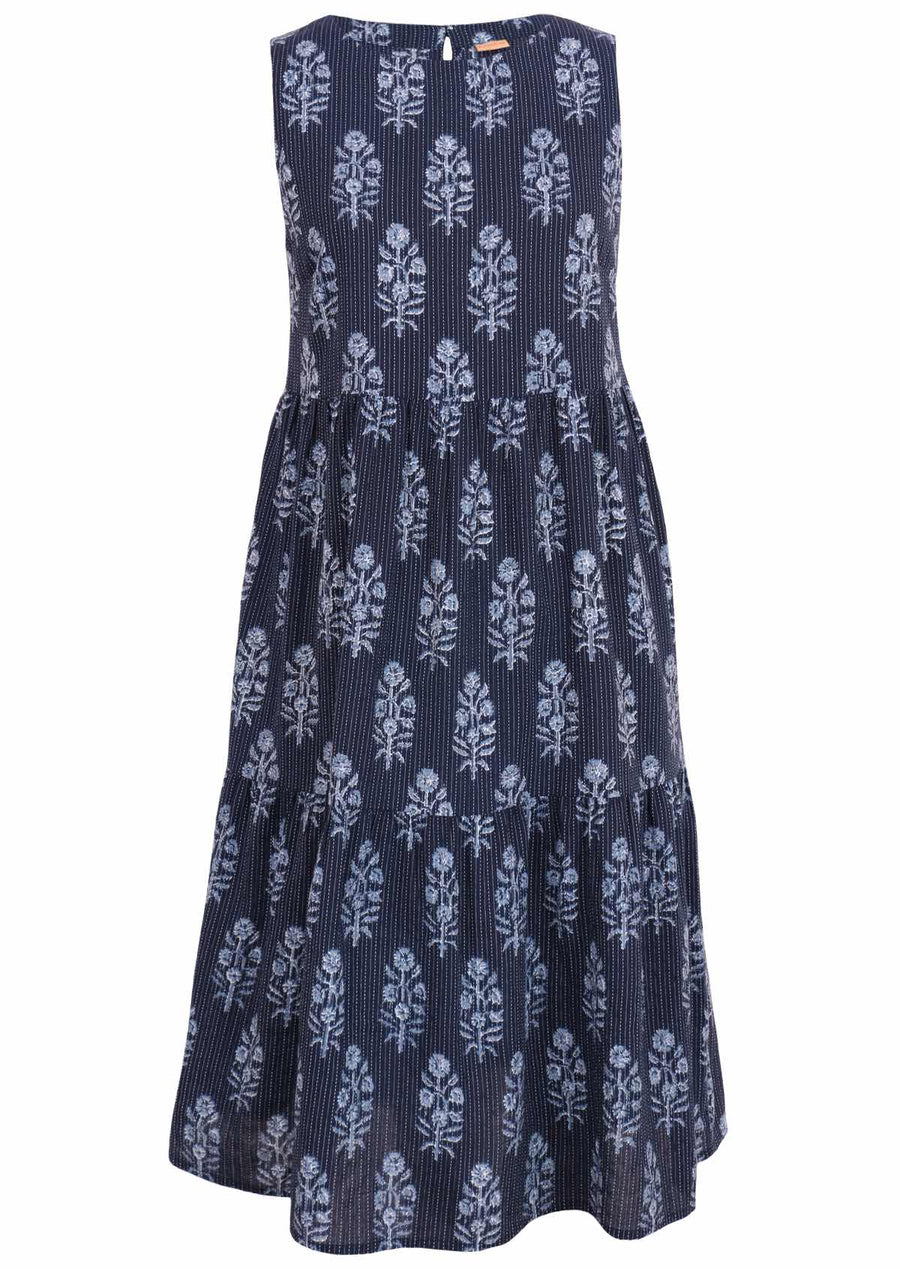 Model wears Tully Dress Delphi blue print with running top stitches, sleeveless three tiered dress with hidden pockets