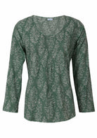 Lightweight 100% cotton top showcasing a simple round neckline, long sleeves and pleats across the bodice.