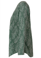 Side image of long sleeve cotton top with sage green based floral print.