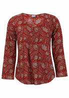 Lightweight 100% cotton top showcasing a simple round neckline, long sleeves and pleats across the bodice.
