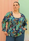 plus sized model wearing bright coloured long sleeve cotton top 