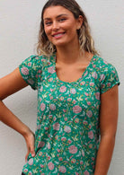 Close up of model smiling wearing 100 percent cotton short sleeve pleated top 