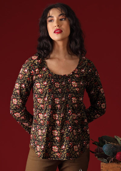Model with dark hair wearing long sleeve scoop neck cotton women's blouse