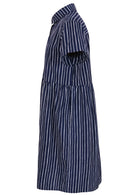 Side view of shikari print on dark blue base cotton relaxed fit collared short sleeve dress with hidden side pockets