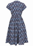 Back view of 50's style cotton midi length dress with a waist tie and cap sleeves