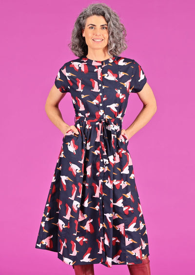 Vivien Dress Percival retro cotton dark blue base with pink maroon mustard pelican print fabric belt button through front with pockets