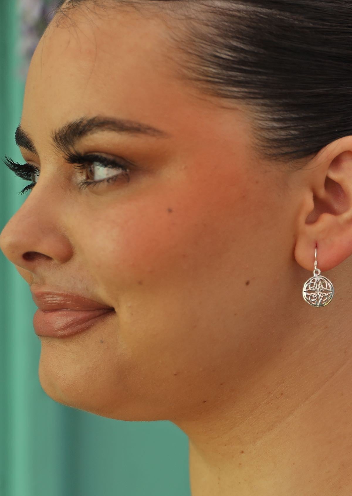 celtic style circle dangle earrings on woman with dark hair