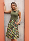 Model wears green on black base cotton skirt with pockets
