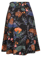 100% cotton black printed midlength A-line skirt with a wide waistband, pockets, and side zipper