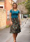 Model wears over knee length cotton skirt with black base