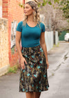 Model wears over knee cotton black skirt with wide yoke