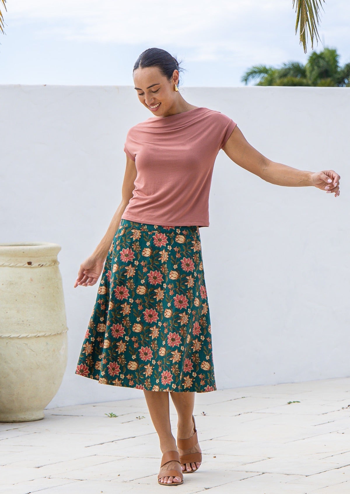 Model wears 100% cotton A line, below the knee length skirt with wide waistband and side zipper.