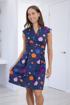 Model poses in V-neck Knee Length retro inspired Dress with cap sleeves and structured bodice