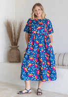 Woman wearing a 100% cotton dress in royal blue based floral print 