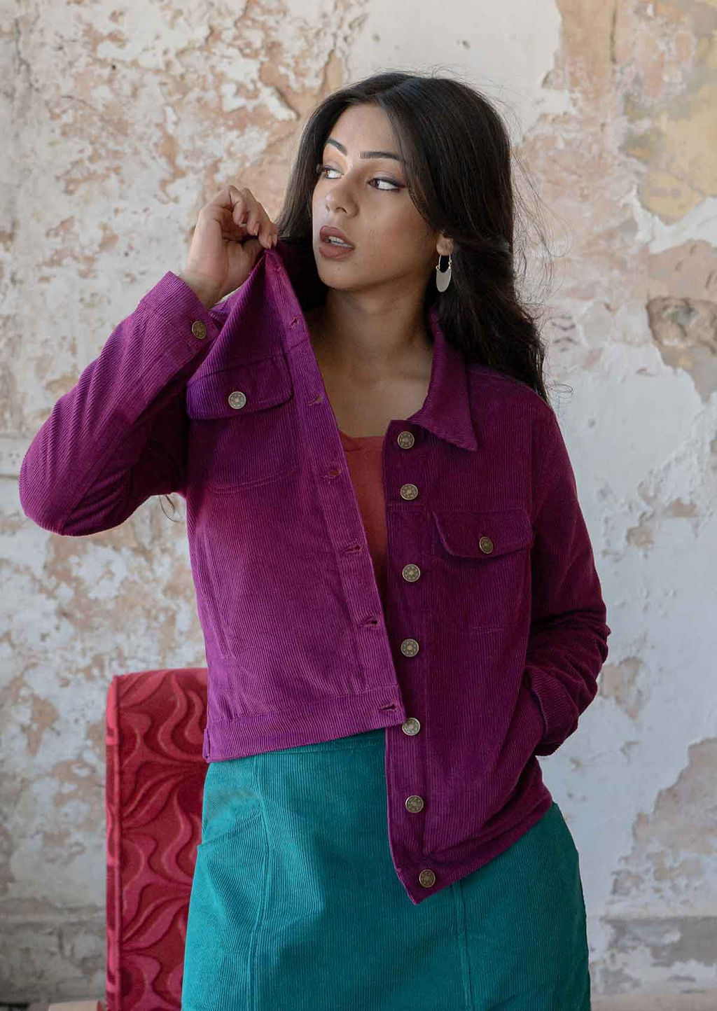Woman posing wearing 100% cotton corduroy jacket with brass buttons, a collar, breast and front pockets
