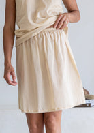 Close up of nude toned cotton voile above knee slip skirt with picot trim