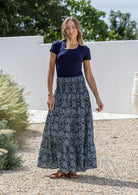 woman wearing a simple navy top and 100% cotton maxi skirt in navy blue based floral print. 