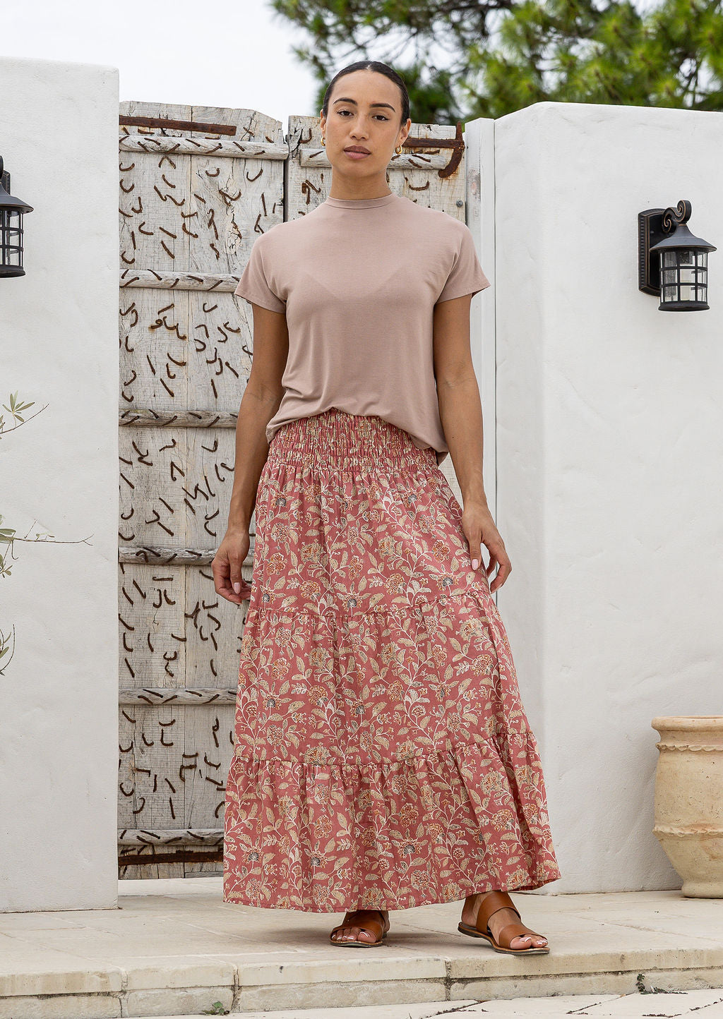 woman wearing a simple pink top and 100% cotton maxi skirt in rose pink based floral print. 