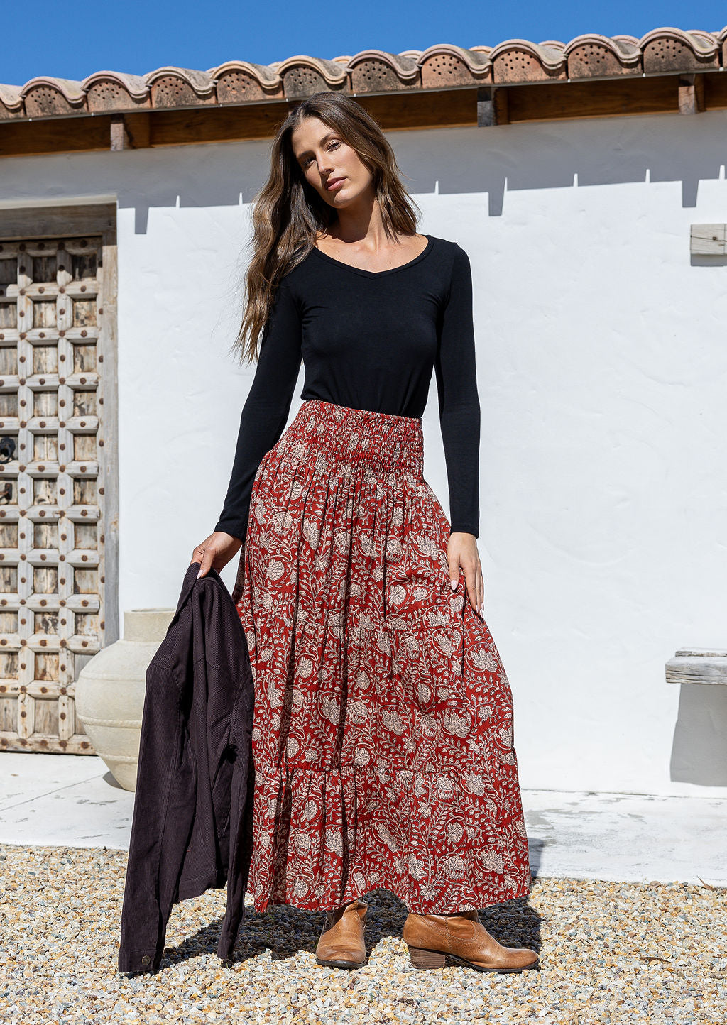 woman wearing a simple black top and 100% cotton maxi skirt in red based floral print. 