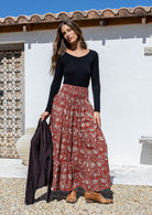 woman wearing a simple black top and 100% cotton maxi skirt in red based floral print. 