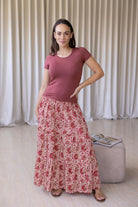 woman wearing a simple pink top and 100% cotton maxi skirt in gentle cream based floral print