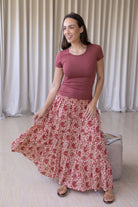 Model flaunting gentle cream based floral print cotton maxi skirt with a wide shirred elastic waistband.