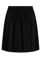 Black slight A-line cotton slip skirt with elasticated waist and picot trim on hem, front view