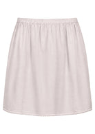 White slight A-line cotton slip skirt with elasticated waist and picot trim on hem, front view