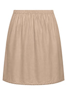 Nude toned slight A-line cotton slip skirt with elasticated waist and picot trim on hem, back view