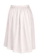 White slight A-line cotton slip skirt with elasticated waist and picot trim on hem, side view