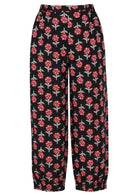 Back view of 100% cotton wide leg pants with elastic waist and pockets in black based floral print.
