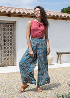 woman wearing wide legged blue based floral print rayon pants with a basic top