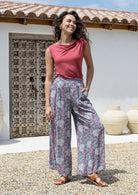 woman wearing wide legged blue based floral print rayon pants with a basic top