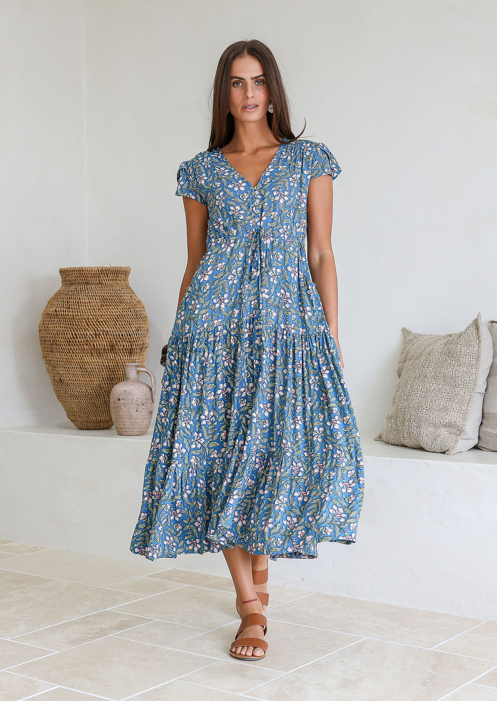 Model wears rayon maxi dress with tulip sleeves, V-neckline and voluminous skirt