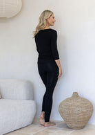 Woman standing backwards wearing a super soft stretch rayon leggings black