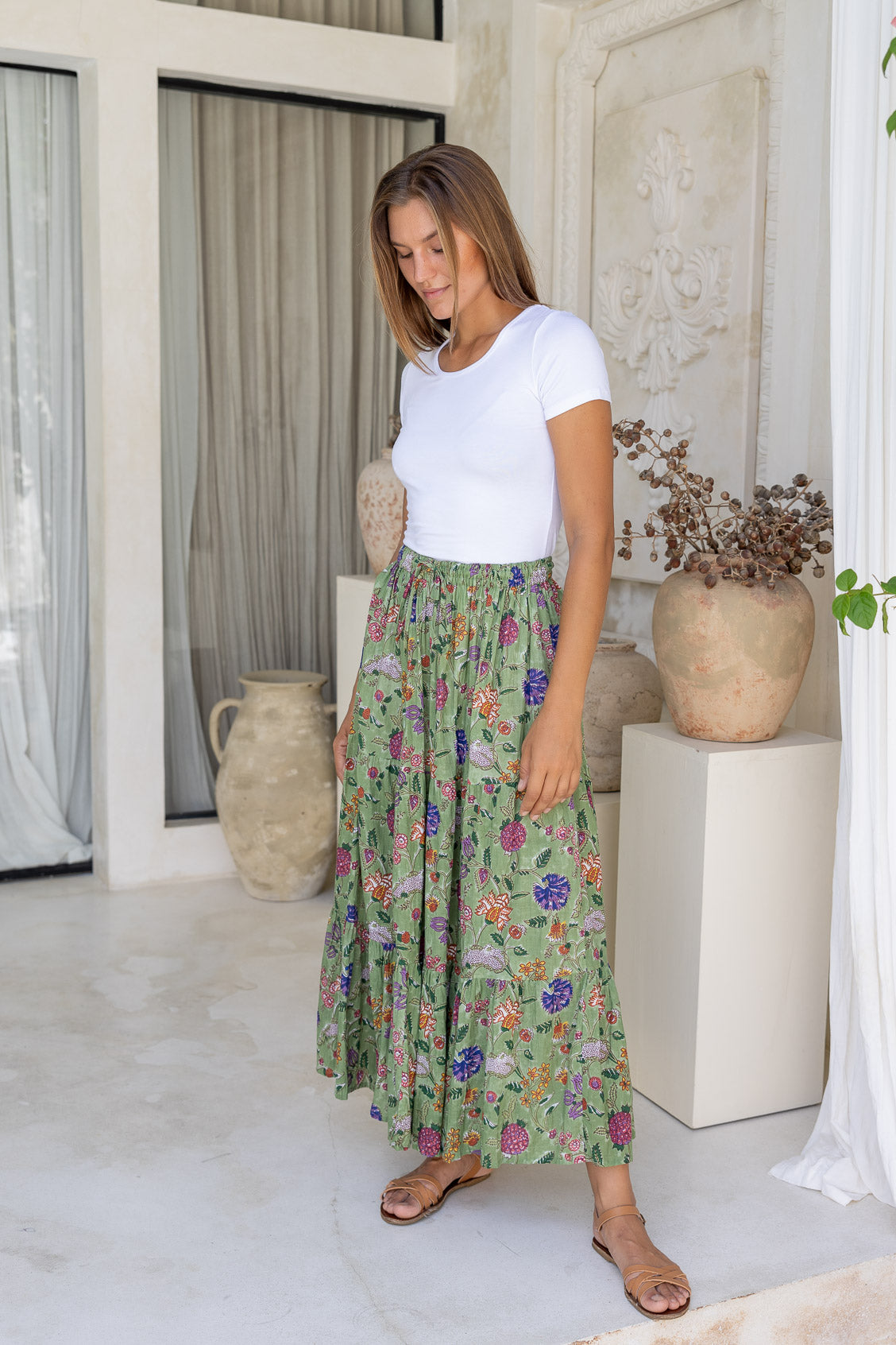 Model pairs crinkled, floral cotton maxi skirt with white rayon top 
