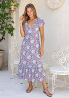 Model standing and wearing 100 percent rayon maxi dress with butterfly
sleeves and v-neck