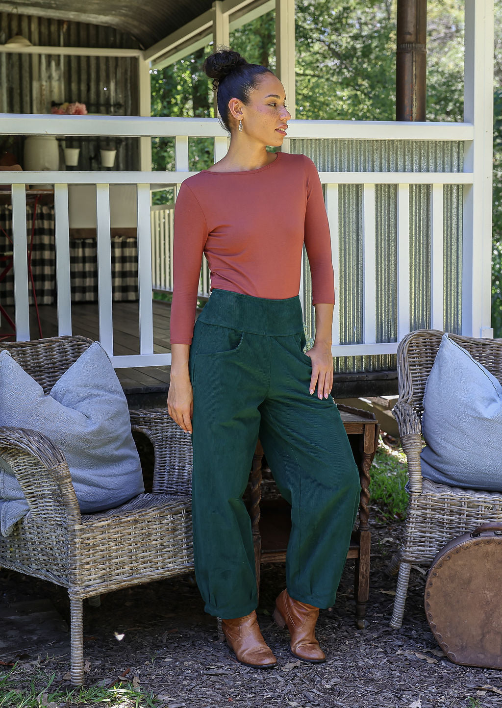 Woman wearing a  cotton corduroy wide-leg dark green pants with basic top