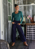 Woman wearing a cotton corduroy wide-leg navy blue pants with hand in pockets